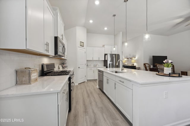 120 Sifted Grain Rd, Bluffton, SC 29909 - kitchen with appliances with stainless steel finishes, a sink, white cabinetry, an island with sink, and lofted ceiling