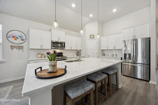 120 Sifted Grain Rd, Bluffton, SC 29909 - kitchen featuring stainless steel appliances, dark wood-style flooring, a sink, white cabinetry, and tasteful backsplash
