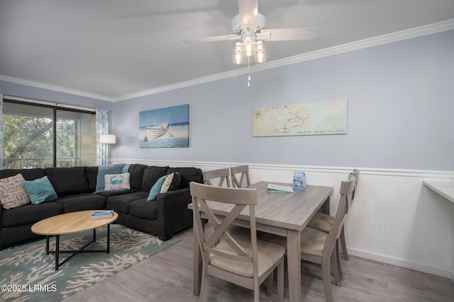 663 William Hilton Pkwy Unit 2126, Hilton Head Island, SC 29928 - dining space featuring a ceiling fan, crown molding, wood finished floors, and a wainscoted wall