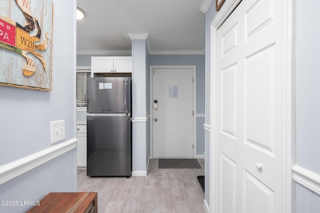 663 William Hilton Pkwy Unit 2126, Hilton Head Island, SC 29928 - kitchen featuring freestanding refrigerator, ornamental molding, light wood-style flooring, and white cabinets
