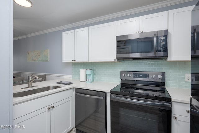 663 William Hilton Pkwy Unit 2126, Hilton Head Island, SC 29928 - kitchen with stainless steel appliances, ornamental molding, white cabinetry, light countertops, and decorative backsplash