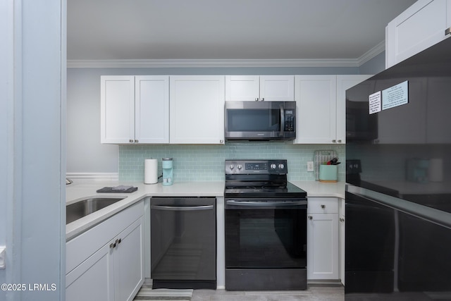 663 William Hilton Pkwy Unit 2126, Hilton Head Island, SC 29928 - kitchen with black appliances, white cabinetry, ornamental molding, decorative backsplash, and light countertops