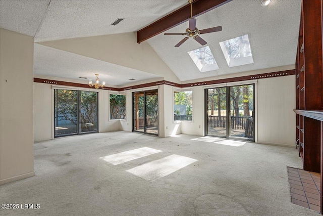 unfurnished living room featuring a textured ceiling, carpet floors, a skylight, visible vents, and beamed ceiling