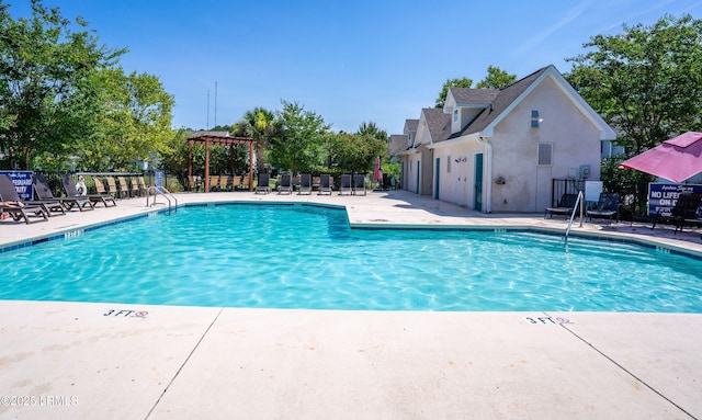 view of swimming pool featuring a pergola and a patio area