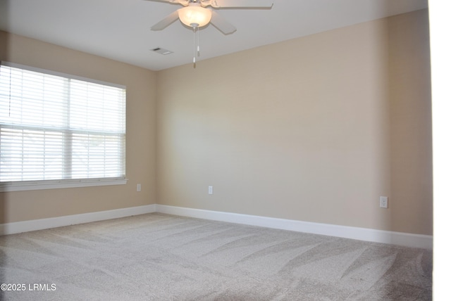 carpeted empty room featuring ceiling fan