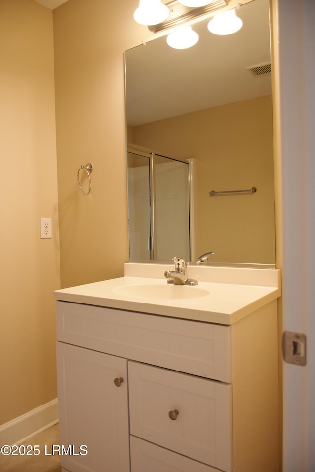 bathroom featuring vanity and an enclosed shower