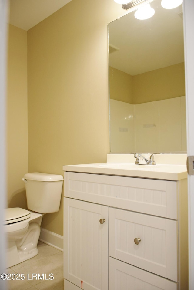 bathroom with vanity, tile patterned floors, and toilet