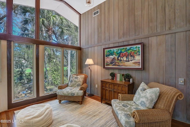 34 W Beach Lagoon Dr, Hilton Head Island, SC 29928 - sitting room with visible vents, wood finished floors, high vaulted ceiling, and wood walls