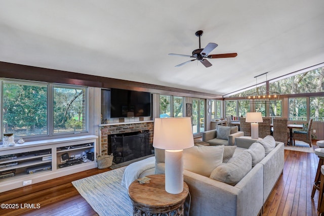 34 W Beach Lagoon Dr, Hilton Head Island, SC 29928 - living room with vaulted ceiling, hardwood / wood-style flooring, a fireplace, and ceiling fan