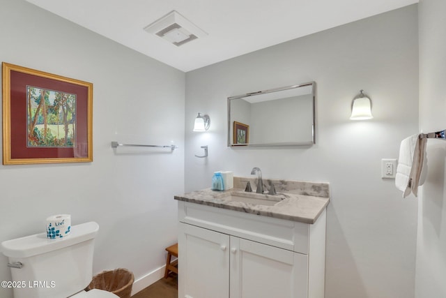 34 W Beach Lagoon Dr, Hilton Head Island, SC 29928 - half bath featuring visible vents, baseboards, toilet, and vanity