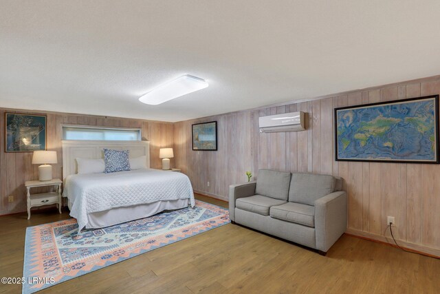 34 W Beach Lagoon Dr, Hilton Head Island, SC 29928 - bedroom with a wall mounted AC, baseboards, and wood finished floors