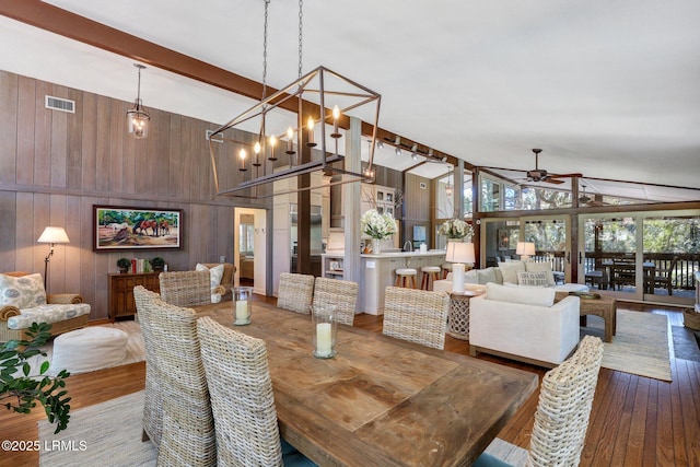 34 W Beach Lagoon Dr, Hilton Head Island, SC 29928 - dining room featuring wooden walls, visible vents, ceiling fan, beamed ceiling, and wood finished floors