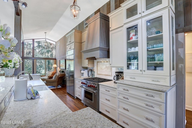 34 W Beach Lagoon Dr, Hilton Head Island, SC 29928 - kitchen with dark wood-style floors, light stone countertops, custom exhaust hood, a sink, and high quality appliances