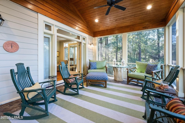 sunroom featuring vaulted ceiling, wooden ceiling, and ceiling fan