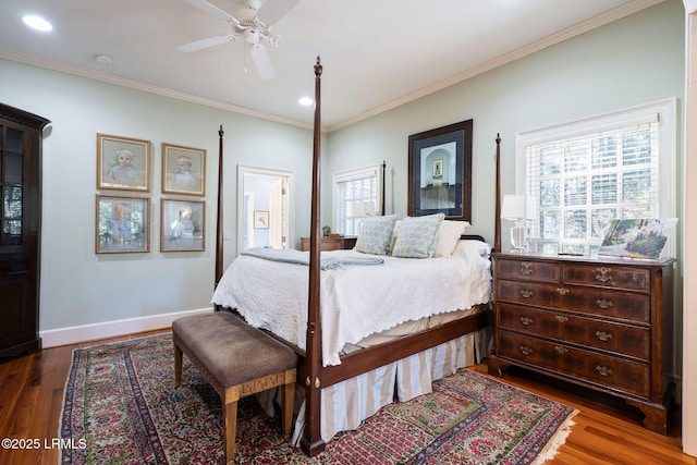 bedroom with ceiling fan, crown molding, and dark hardwood / wood-style flooring