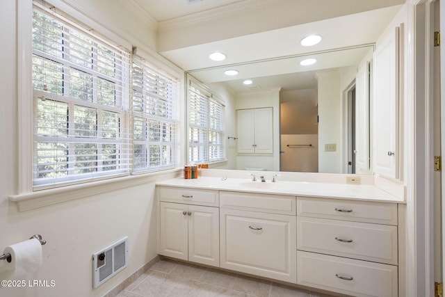 bathroom featuring vanity, crown molding, and tile patterned floors