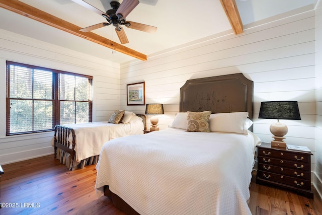 bedroom with beamed ceiling, ceiling fan, and hardwood / wood-style floors