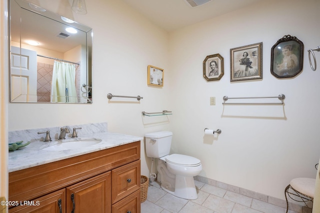 bathroom with vanity, walk in shower, tile patterned floors, and toilet