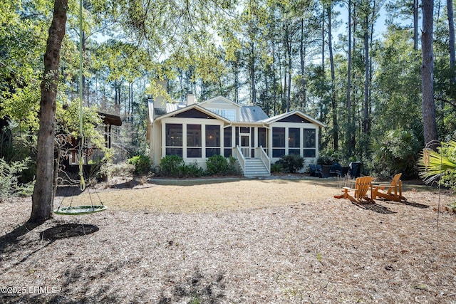 rear view of property with a sunroom