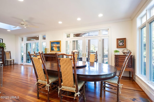 dining area with french doors, ornamental molding, dark hardwood / wood-style floors, and a wealth of natural light