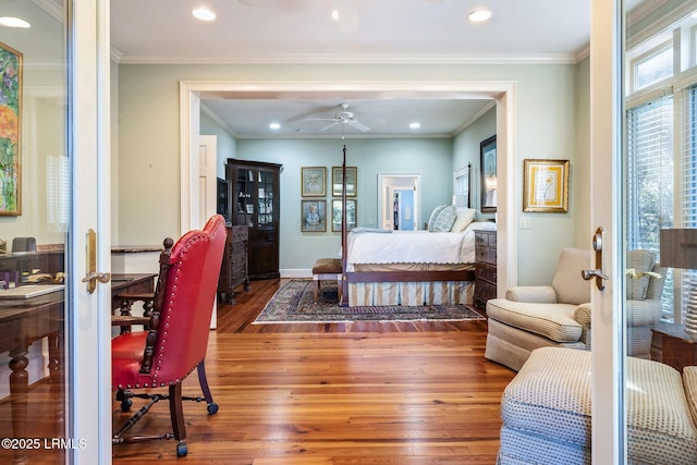 bedroom with crown molding and hardwood / wood-style floors