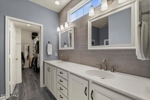 101 Redtail Dr, Bluffton, SC 29909 - bathroom with backsplash, double vanity, wood finished floors, and a spacious closet