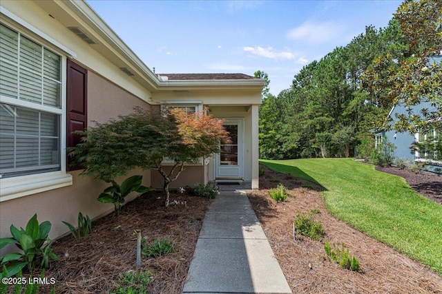 101 Redtail Dr, Bluffton, SC 29909 - doorway to property featuring stucco siding and a yard