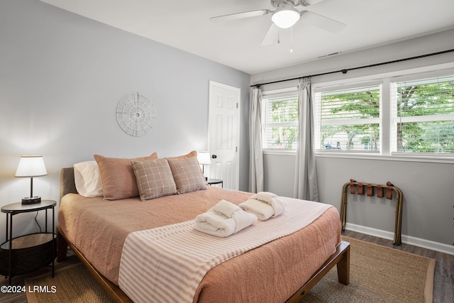 bedroom with wood-type flooring and ceiling fan