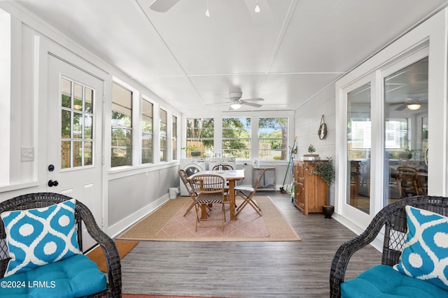 sunroom / solarium featuring a healthy amount of sunlight and ceiling fan