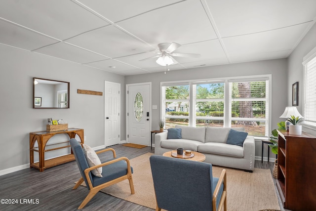 living room with dark wood-type flooring and ceiling fan