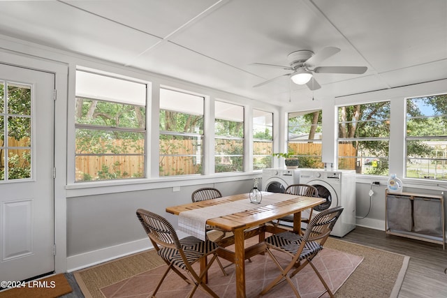 sunroom with ceiling fan, washing machine and clothes dryer, and a paneled ceiling