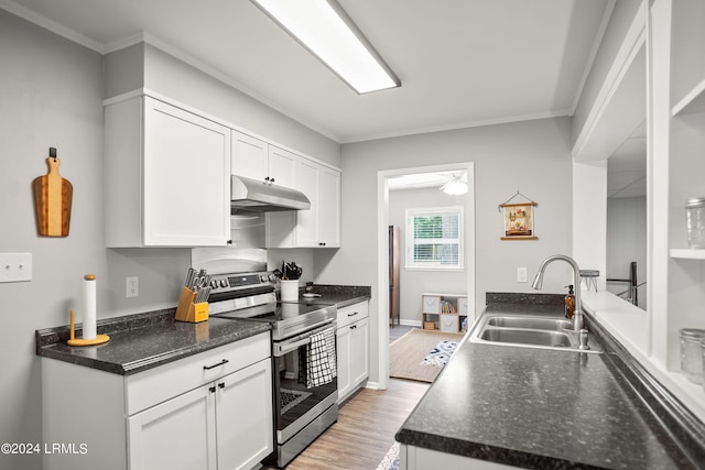 kitchen featuring stainless steel range with electric stovetop, sink, and white cabinetry