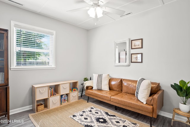 living room with dark wood-type flooring and ceiling fan