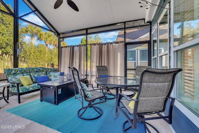 sunroom / solarium with vaulted ceiling and a ceiling fan