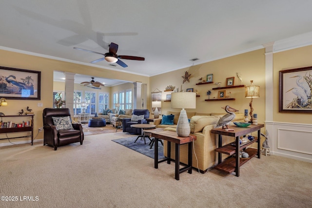 living room with light colored carpet, crown molding, visible vents, and ornate columns