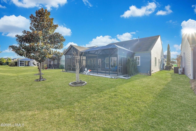 rear view of house with a lawn and central air condition unit