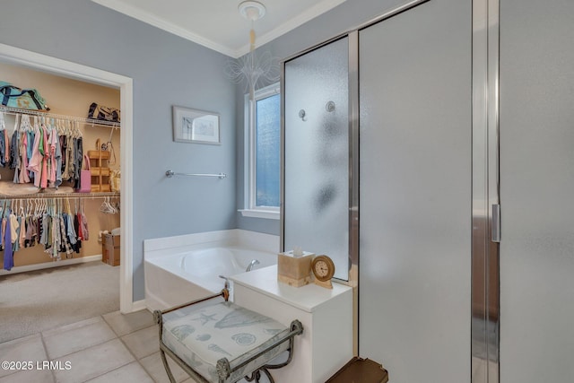 bathroom featuring a stall shower, a garden tub, a walk in closet, and crown molding