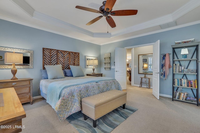 bedroom featuring a tray ceiling, carpet flooring, and ornamental molding