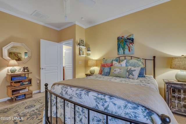 carpeted bedroom featuring ceiling fan, ornamental molding, visible vents, and baseboards