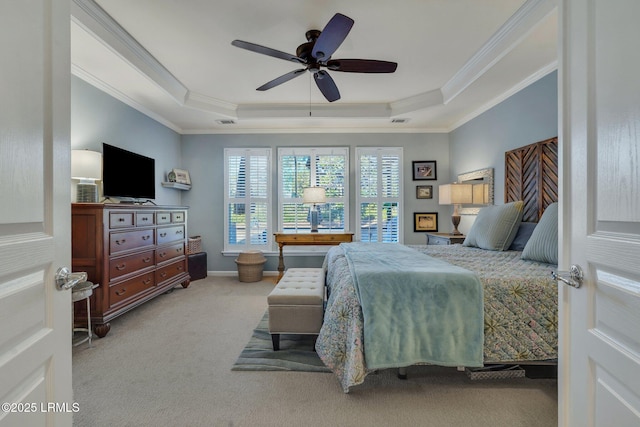 carpeted bedroom featuring ornamental molding, a tray ceiling, and visible vents