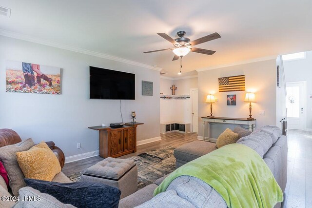 living room featuring crown molding, ceiling fan, and light hardwood / wood-style flooring