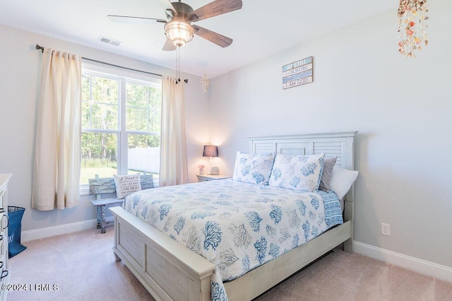 bedroom with ceiling fan and light carpet