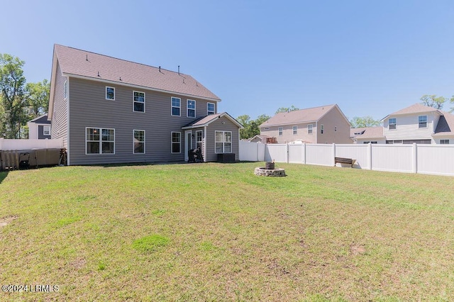 rear view of house with a yard