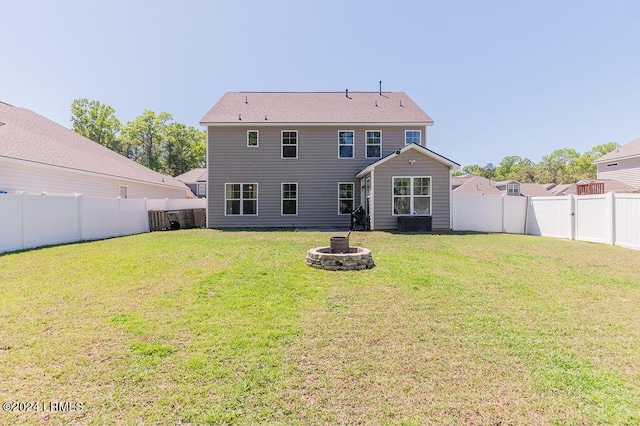 rear view of house with a yard