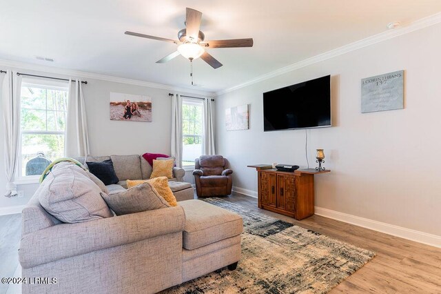 living room with crown molding, ceiling fan, hardwood / wood-style floors, and a wealth of natural light