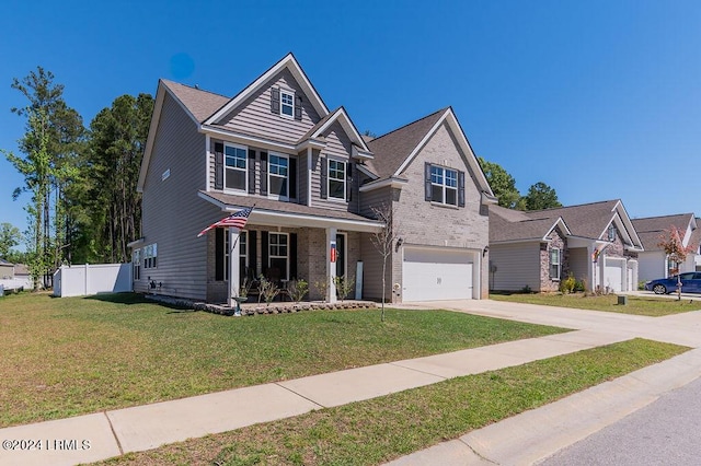 view of front of house featuring a garage, a front yard, and covered porch