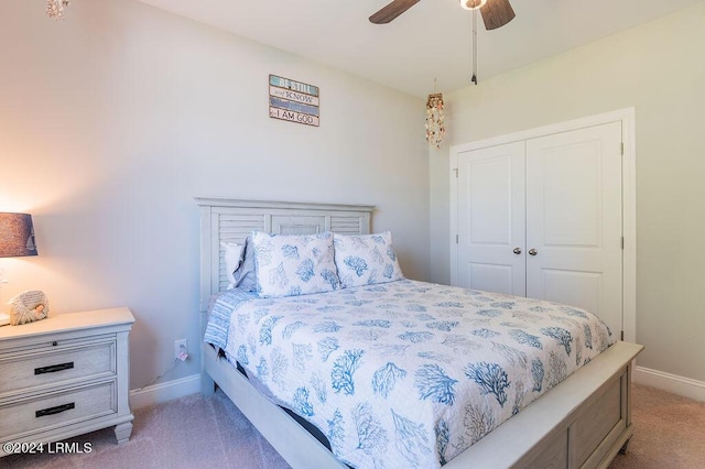 bedroom featuring light colored carpet, a closet, and ceiling fan