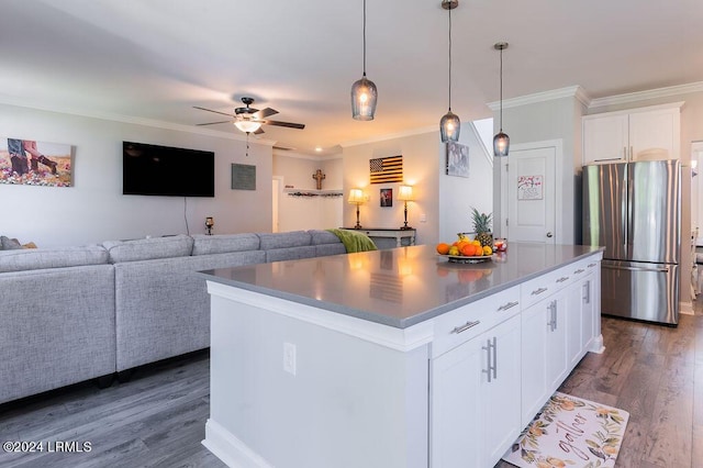 kitchen with white cabinetry, stainless steel fridge, and a kitchen island