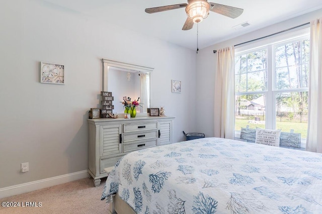 bedroom featuring light carpet and ceiling fan