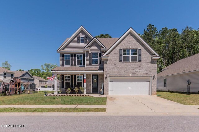 craftsman inspired home with a garage and a front lawn